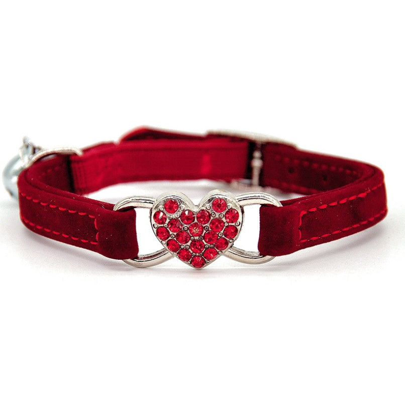 Adjustable safety cat collar with dainty heart charm, featuring a colorful design and secure buckle for a stylish feline accessory.