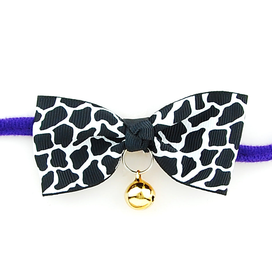 PetVibe™ polka-dot party bow collar on a small dog, featuring a colorful polka-dot pattern and adjustable strap for a stylish pet look.