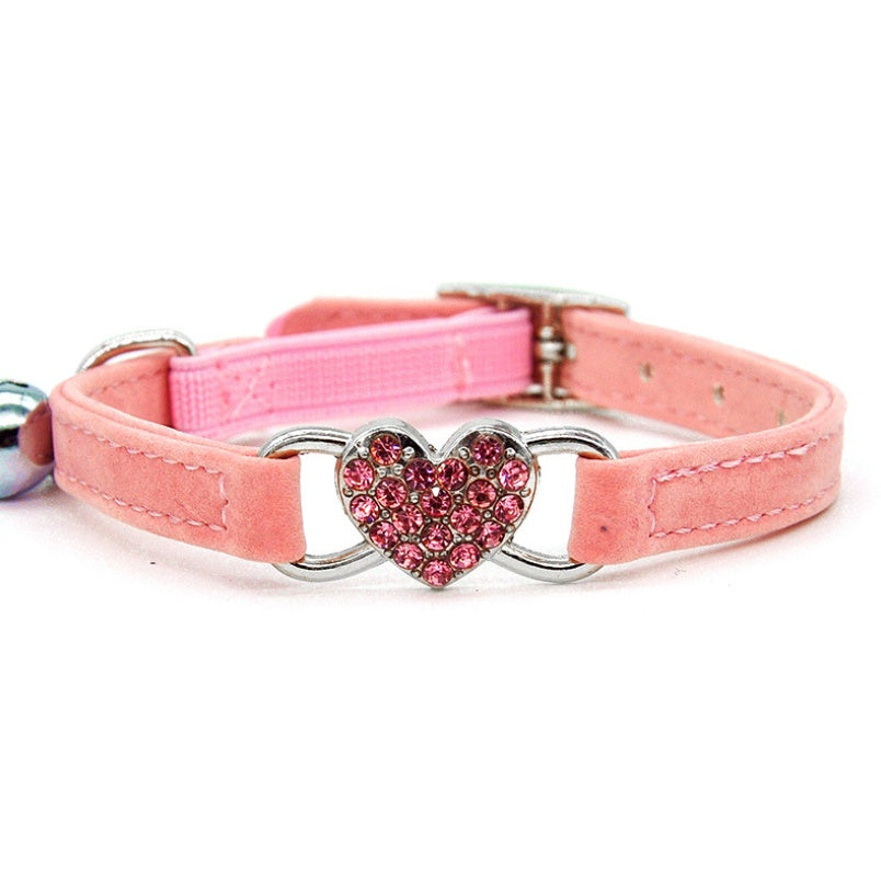 Adjustable safety cat collar with dainty heart charm, featuring a secure buckle and soft material for comfortable wear.
